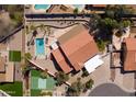 Stunning aerial view showcasing backyard oasis with sparkling pool, tennis court, and lush landscaping at 1327 E Le Marche Ave, Phoenix, AZ 85022