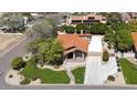 An aerial view of this well landscaped home with a tile roof, sidewalks, and lush green lawn at 1530 E Jeanine Dr, Tempe, AZ 85284
