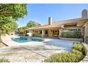 Inviting backyard pool surrounded by stone patio, perfect for relaxing and entertaining at 1530 E Jeanine Dr, Tempe, AZ 85284