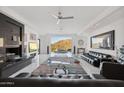 Open concept living room featuring glossy tile floors, a sleek fireplace, and a scenic view of the mountains at 1721 E Hatcher Dr, Phoenix, AZ 85020