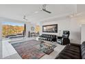 Spacious living room featuring large windows with views of the mountains, glossy tile floors, and modern decor at 1721 E Hatcher Dr, Phoenix, AZ 85020