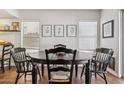 Dining room with a wooden table and chairs, tile floors, and a view of the backyard at 17211 N 46Th Pl, Phoenix, AZ 85032