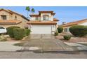 Two-story home with a red tile roof, two-car garage, and desert landscaping in the front yard at 17211 N 46Th Pl, Phoenix, AZ 85032
