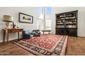 Bright living room features a high ceiling, large windows, and a cozy seating area with an area rug at 17211 N 46Th Pl, Phoenix, AZ 85032