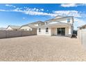 Expansive backyard with sliding glass door and stucco wall offers outdoor living potential at 17648 W Sanna St, Waddell, AZ 85355