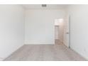 Bright bedroom with carpet, closet, and an open doorway at 17704 W Mission Ln, Waddell, AZ 85355
