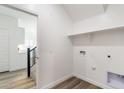 Bright laundry room with a shelf, washer, and dryer hookups at 17704 W Mission Ln, Waddell, AZ 85355