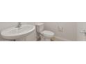 Powder room featuring modern sink and toilet with chrome fixtures and tile floor at 17788 W Getty Dr, Goodyear, AZ 85338