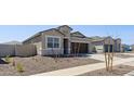 Charming single-story home with desert landscaping and a sidewalk, featuring a well-kept lawn at 18377 W Gray Fox Trl, Wittmann, AZ 85361