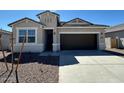 Charming single-Gathering home featuring a two-car garage, desert landscaping, and a welcoming entrance at 18377 W Gray Fox Trl, Wittmann, AZ 85361