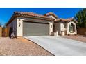 Exterior showcasing a well-kept home with a spacious driveway leading to a two-car garage and desert landscaping at 1980 E Horseshoe Dr, Chandler, AZ 85249