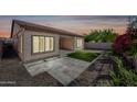 A well-manicured backyard featuring modern landscaping, covered patio, and block wall that offers privacy at 2040 N Dome Rock --, Mesa, AZ 85207