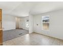 Inviting living room with carpet and tile flooring with natural light from windows at 2145 N Silverton St, Mesa, AZ 85203