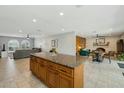 Open-concept kitchen with a large island and breakfast bar, seamlessly connecting to the living spaces at 2405 E Balboa Dr, Tempe, AZ 85282