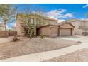 Two-story home with three-car garage and desert landscaping under a blue sky at 3239 E San Manuel Rd, San Tan Valley, AZ 85143