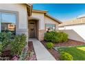 Inviting home exterior with a cozy front door and meticulously maintained landscaping leading to the entrance at 3872 S Seton Ave, Gilbert, AZ 85297