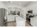 Bright, white kitchen with stainless steel appliances and a center island, perfect for modern living at 3872 S Seton Ave, Gilbert, AZ 85297