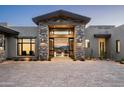 Elegant home entrance featuring stone accents and desert landscaping, offering a glimpse into the beautiful interior at 41248 N 96Th St, Scottsdale, AZ 85262