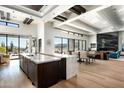 Open-concept kitchen with marble island, wooden cabinets, and a view of the Arizona desert at 41248 N 96Th St, Scottsdale, AZ 85262