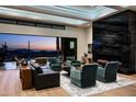 Stylish living room showcasing a contemporary fireplace and expansive sliding glass doors with desert views at dusk at 41248 N 96Th St, Scottsdale, AZ 85262