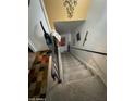 Bright stairwell with carpeted steps and a dark railing, providing access to other levels of the home at 4744 E Portland St, Phoenix, AZ 85008