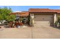 Home exterior with two-car garage and outdoor seating area at 672 Leisure World --, Mesa, AZ 85206