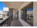 Exterior of the condo shows a second-floor walkway with windows, doors, and metal railings at 7494 E Earll Dr # 308, Scottsdale, AZ 85251
