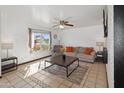 Inviting living area with large windows, tile flooring, ceiling fan, and comfortable furniture at 8410 N 32Nd Ave, Phoenix, AZ 85051