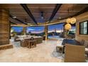 Expansive covered patio with dining and lounging areas overlooking the pool and desert landscape at 9602 E Taos Dr, Scottsdale, AZ 85262