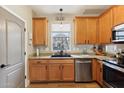 Modern kitchen boasting wood cabinets, stainless steel appliances and granite countertops at 10220 E Isleta Ave, Mesa, AZ 85209