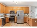 A chef's kitchen with stainless steel appliances, wood cabinets and granite countertops at 10220 E Isleta Ave, Mesa, AZ 85209
