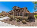 A single-Gathering home shows desert landscaping and a two car garage at 13641 W Jesse Red Dr, Peoria, AZ 85383