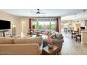 Comfortable living room showcasing a large window, neutral tones, and inviting furnishings at 15613 W Minnezona Ave, Goodyear, AZ 85395