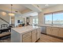 Modern kitchen with white cabinets, stainless steel appliances, and a center island that opens to the living areas at 16248 E Ridgeline Dr, Fountain Hills, AZ 85268