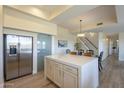 Modern kitchen with white cabinets, stainless steel appliances, and a center island that opens to the living areas at 16248 E Ridgeline Dr, Fountain Hills, AZ 85268