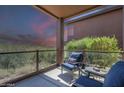 Relaxing covered patio featuring comfortable seating, glass railings, and picturesque desert views at 16248 E Ridgeline Dr, Fountain Hills, AZ 85268
