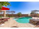 Sparkling backyard pool and patio area is perfect for outdoor entertaining at 16291 W Crenshaw Dr, Surprise, AZ 85379