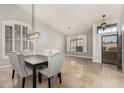 Elegant dining room featuring large windows with shutters, stylish lighting, and travertine flooring at 18036 N 49Th St, Scottsdale, AZ 85254