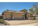 Home showcasing a three-car garage, stone accents, tile roof, and desert landscaping at 2059 W Whisper Rock Trl, Phoenix, AZ 85085