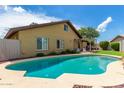 Inviting backyard pool with lush landscaping, perfect for relaxing and entertaining in a private outdoor oasis at 2644 E Sylvia St, Phoenix, AZ 85032