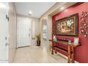 Inviting foyer with tile flooring, neutral walls, and an alcove with a wood table and decorative accents at 2656 E Longhorn Pl, Chandler, AZ 85286