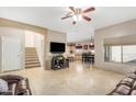 Open-concept layout featuring tile flooring, kitchen, dining and staircase to the second floor at 2656 E Longhorn Pl, Chandler, AZ 85286