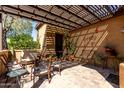 Inviting outdoor patio with pergola, lounge seating, and decorative plants at 26735 N 127Th Dr, Peoria, AZ 85383