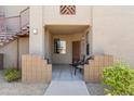 Charming building entrance featuring cozy seating and an inviting outdoor space with wrought iron staircase at 29606 N Tatum Blvd # 128, Cave Creek, AZ 85331