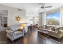 Bright living room featuring wood floors, neutral walls, large windows, ceiling fan and an open floor plan at 29606 N Tatum Blvd # 128, Cave Creek, AZ 85331