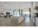 Spacious kitchen flows to the living area, featuring modern appliances and ample counter space at 3015 W Irvine Rd, Phoenix, AZ 85086