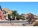 Exterior shot of a home with mountain views, desert landscaping, and an American flag at 4152 N Signal Cir, Mesa, AZ 85215