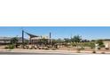Enjoy a community park with playground, covered seating, lush landscaping, and walking paths at 4927 S 106Th Ave, Tolleson, AZ 85353