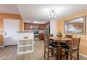 Inviting eat-in kitchen with stainless steel appliances and wooden dining set at 5757 W Eugie Ave # 2081, Glendale, AZ 85304
