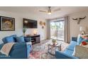 Stylish living room with comfortable seating and access to a private balcony at 5757 W Eugie Ave # 2081, Glendale, AZ 85304